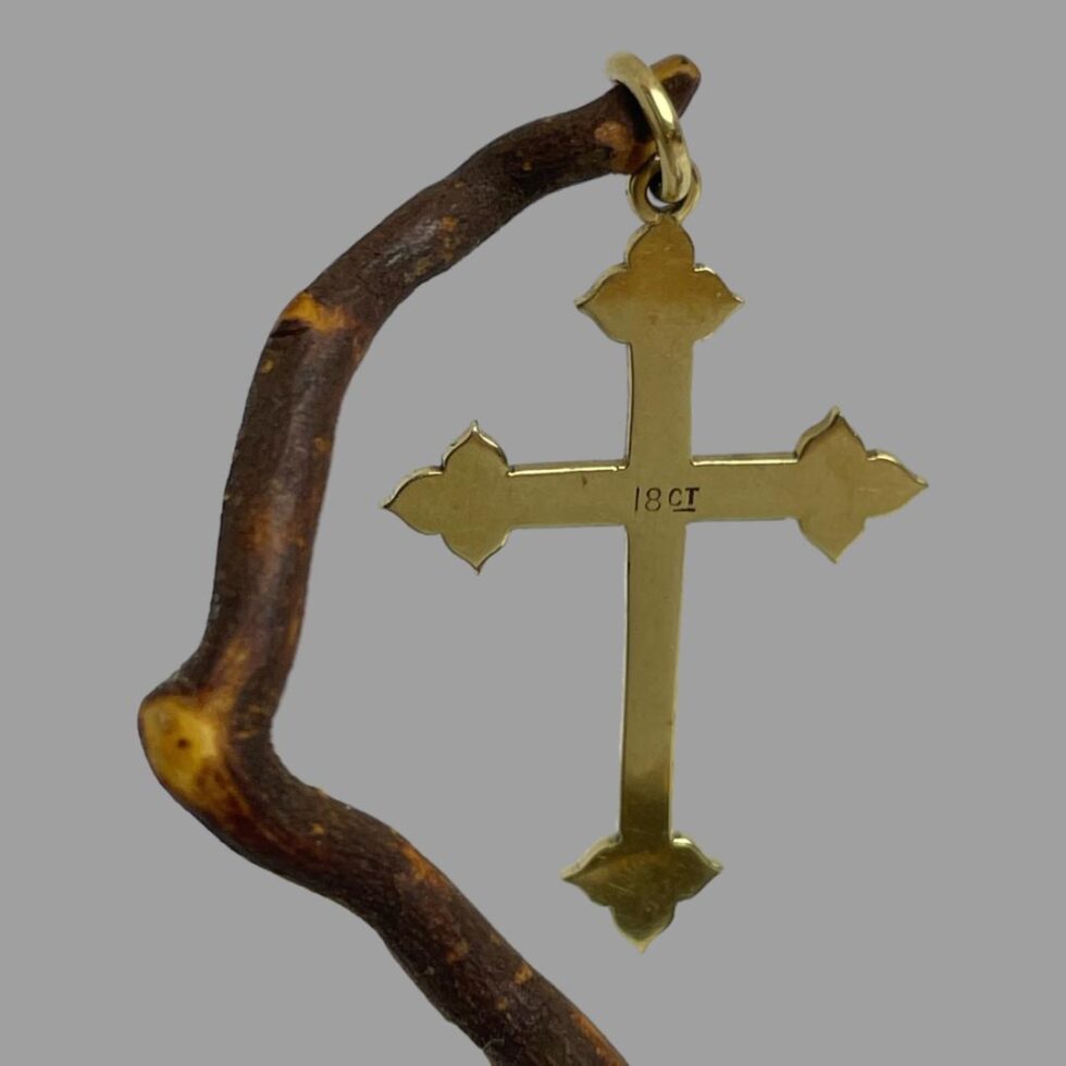 Photo of back of antique 18Kt gold cross with the 18ct hallmark visible at the centre.