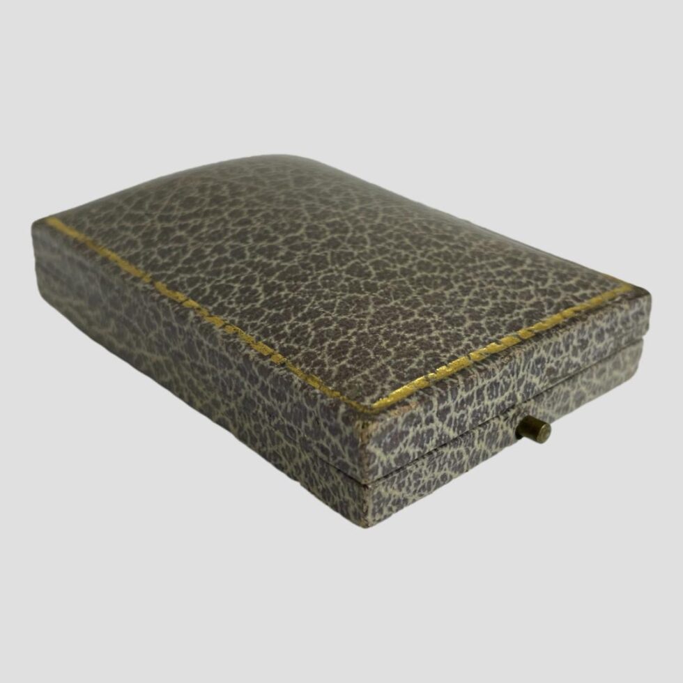 Photo of the original earring box shown closed and with the front end facing bottom right corner.