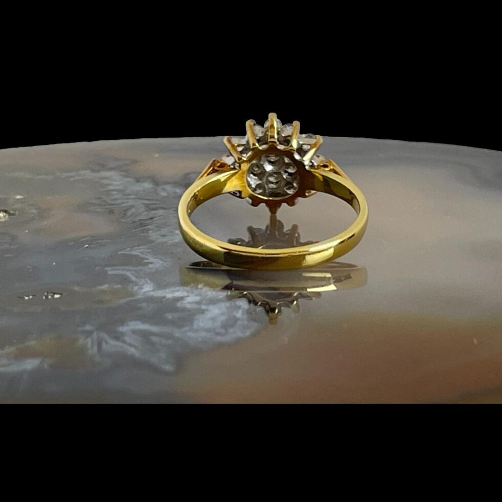 Photo of .50 carat diamond ring photographed facing away from shot showing the claw gallery and setting of the stones.
