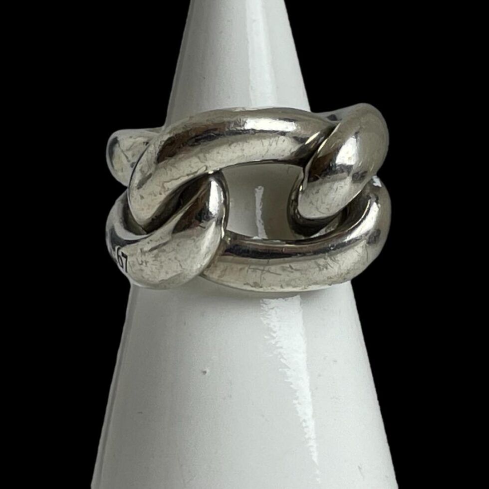 Photo of ring displayed on a white cone shaped stand with the ring front forward facing.