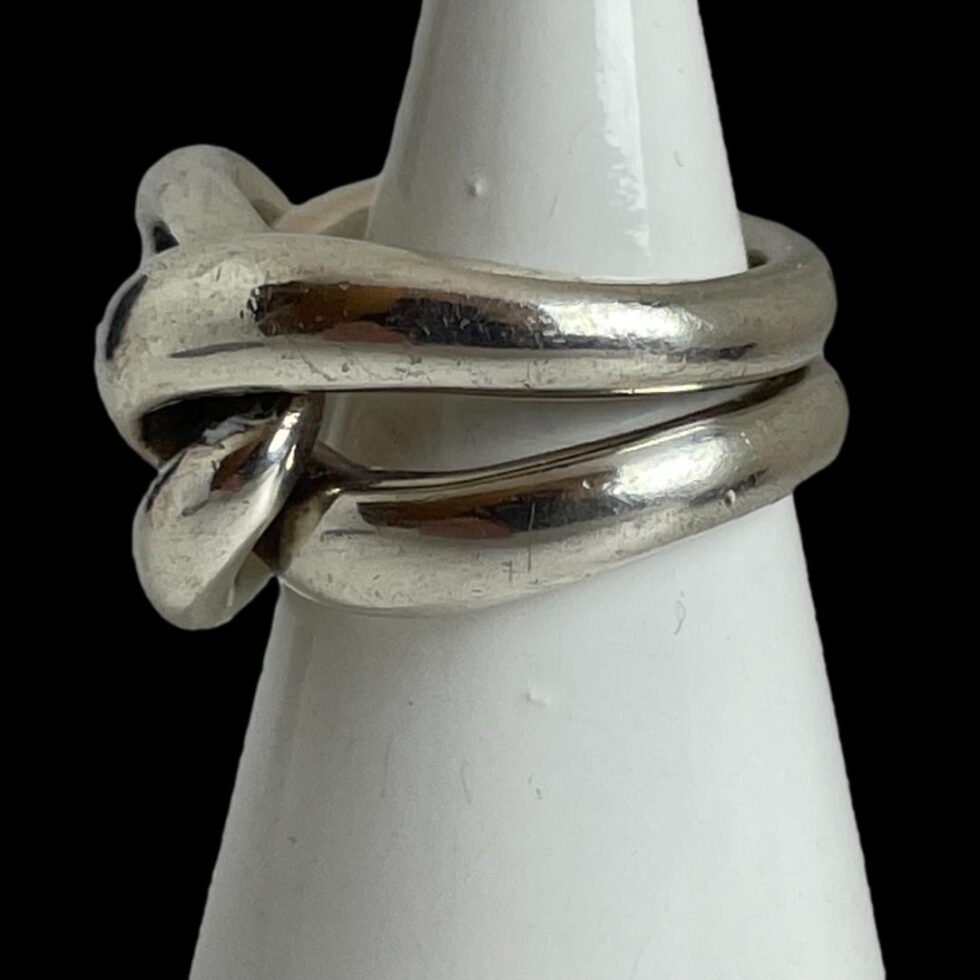 Photo of Pomellato ring displayed on a white cone shaped stand with the ring front facing left.