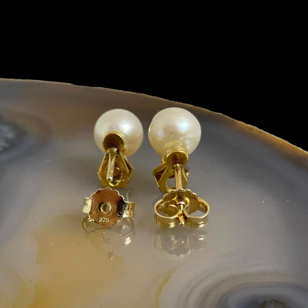 Photo of the back of the earrings with the butterfly removed from the left one and showing the 375 hallmark.