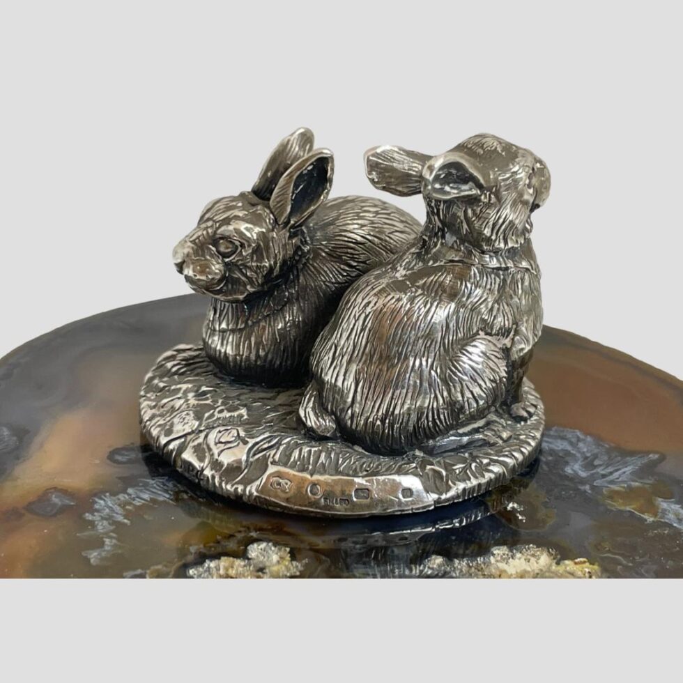 This time the rabbits are displayed opposite position to main photo. A flat smooth area is visible on the base where the hallmark is.