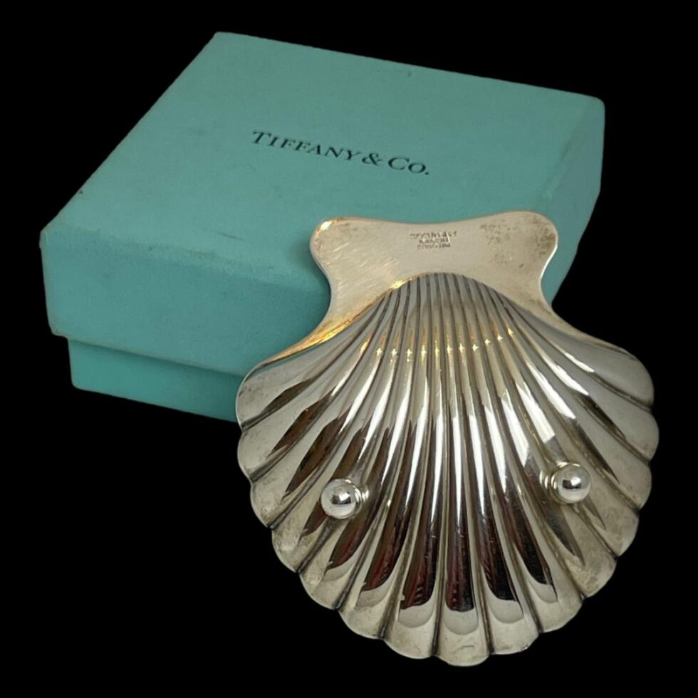 Photo of the pin dish seen from the back showing the 2 ball feet at the front end. The hallmark is visible to the back of the smooth flat edge.