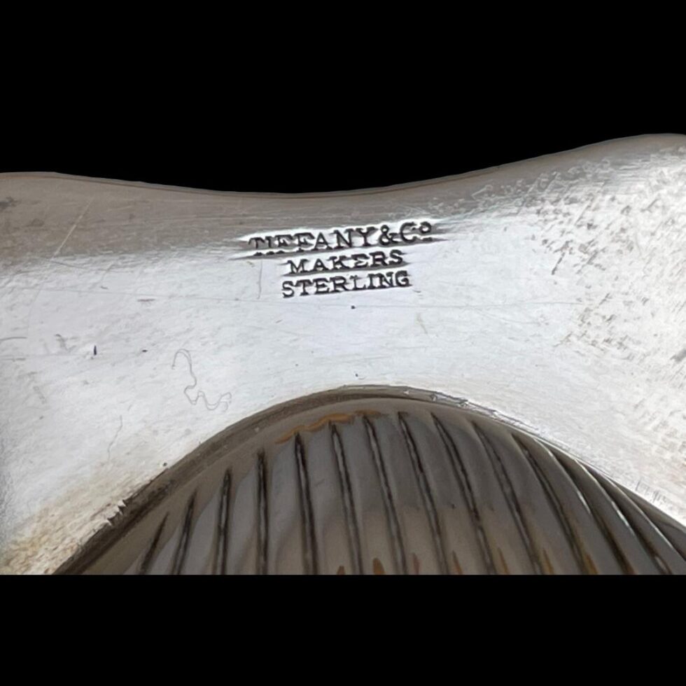 Close up photo of the Tiffany mark and sterling stamp.