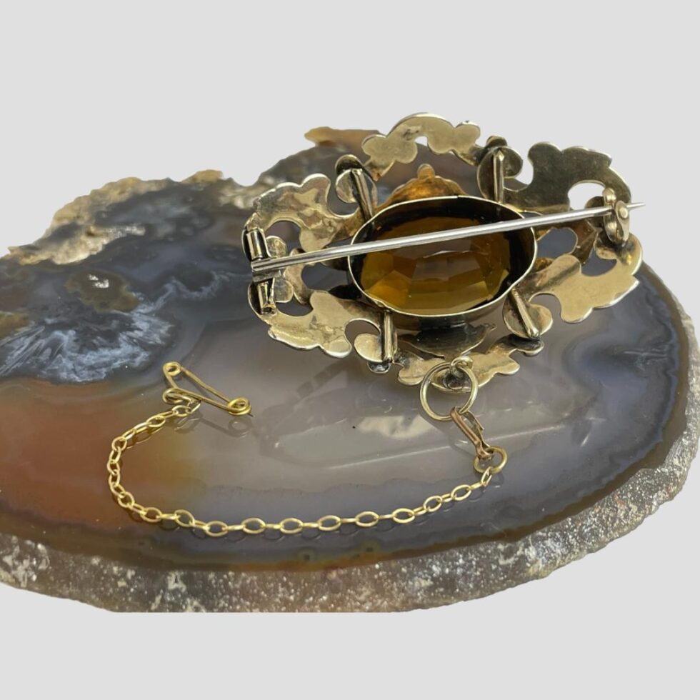 Photo of the back of the brooch with pin shown closed.