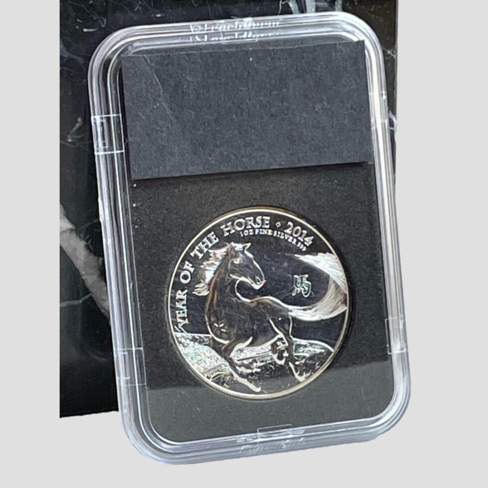 Photo of reverse side of date stamp presentation case displaying just the coin with the horse. The horse is galloping with tail swishing out to the side. Stamped Year of the Horse 2014 1oz fine silver 999 and the Chinese character for horse to the right.
