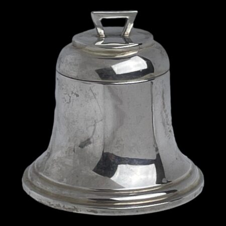 Min photo of antique silver bell inkwell seen with top closed and with the front opening side in the foreground. There is a little arch shaped handle to the top for opening.