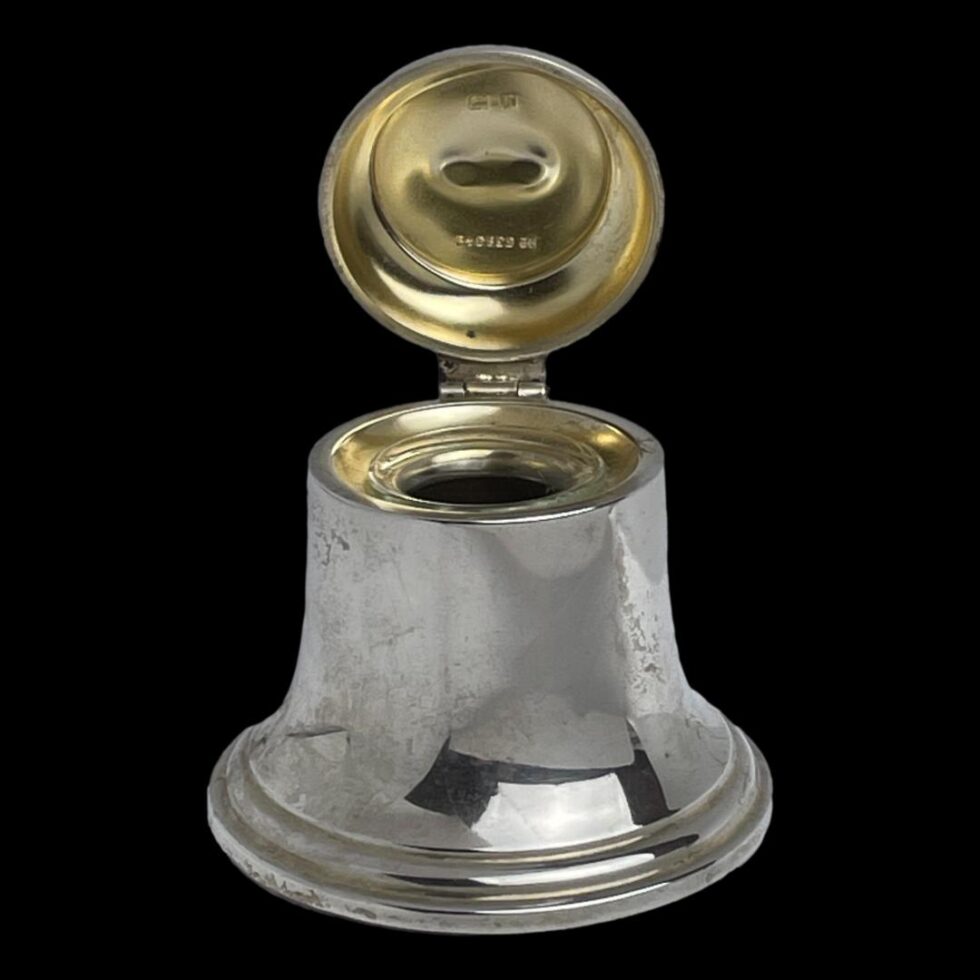 Photo of bell inkwell with the lid open displaying the gilt silver interior to the lid and well. The glass pot is in place and barely visible.