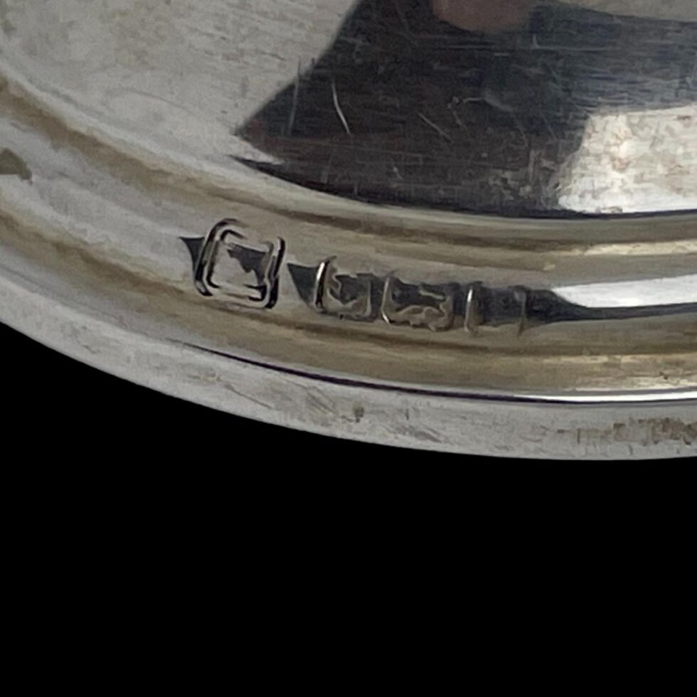 A close up photo of the full hallmark around the base rim of the inkwell.