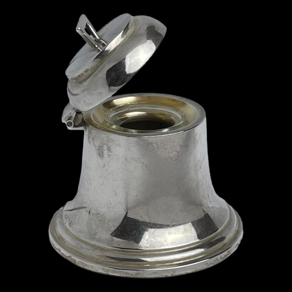 Photo of bell inkwell shown from a side angle with the lid open halfway. The hinge is on the left side.