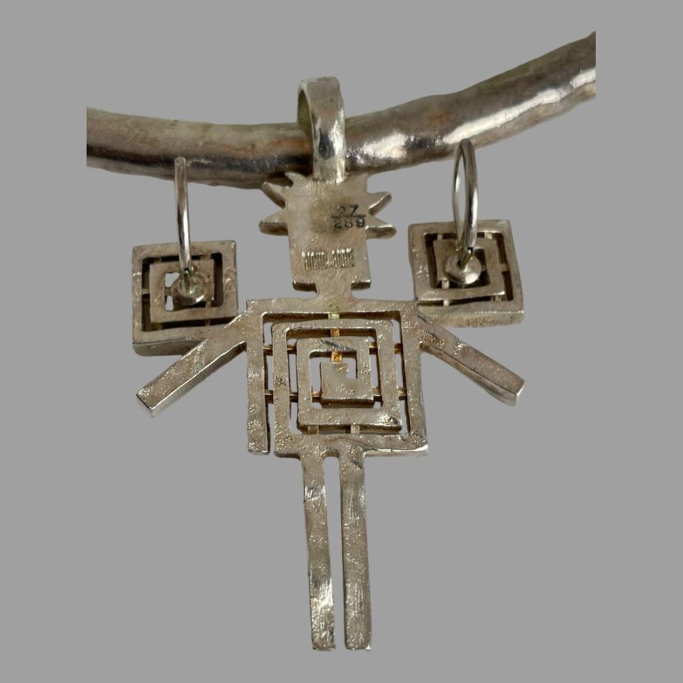 Close up photo of the back of the pendant and earrings showing the Biche de Bere stamp and edition number to the back of the pendant and the BB on the earrings.