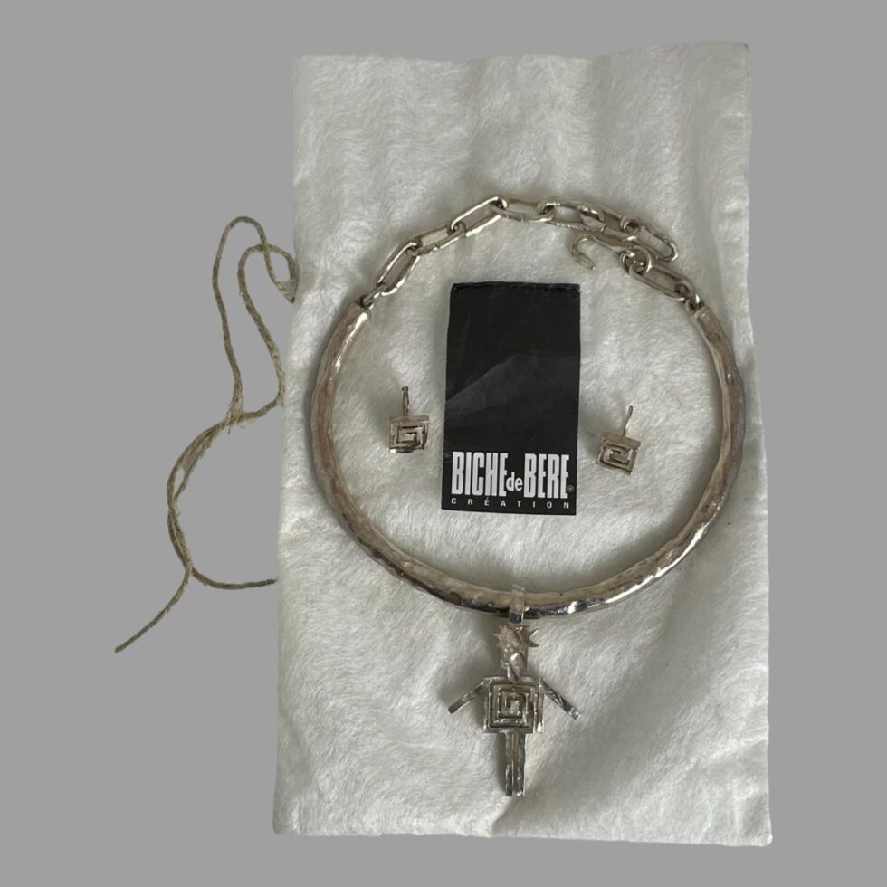 Photo of choker and earrings displayed on top of the original Biche de Bere bag.