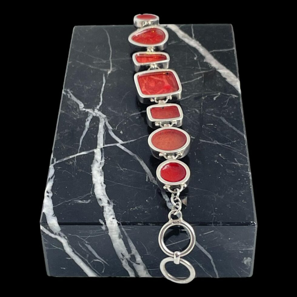 Photo of the back of bracelet (which is still on top of the marble block). The individual silver framing each piece of stone is visible.