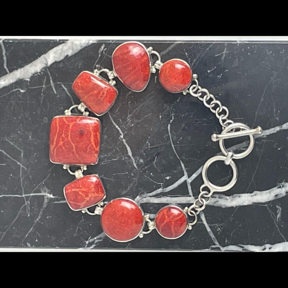 Photo of bracelet displayed on the block of black marble and shown with clasp closed (on end ring) and the bracelet laid in a circle.