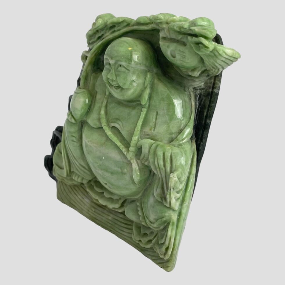 Photo of lucky Buddha figurine this time displayed with the Buddha facing towards the left. The Buddha has a wonderfully joyous laughing face.