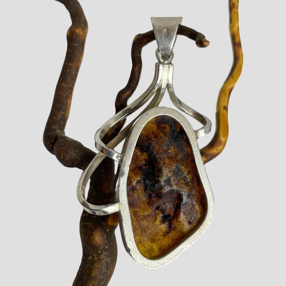 Photo of back of pendant showing the amber setting.