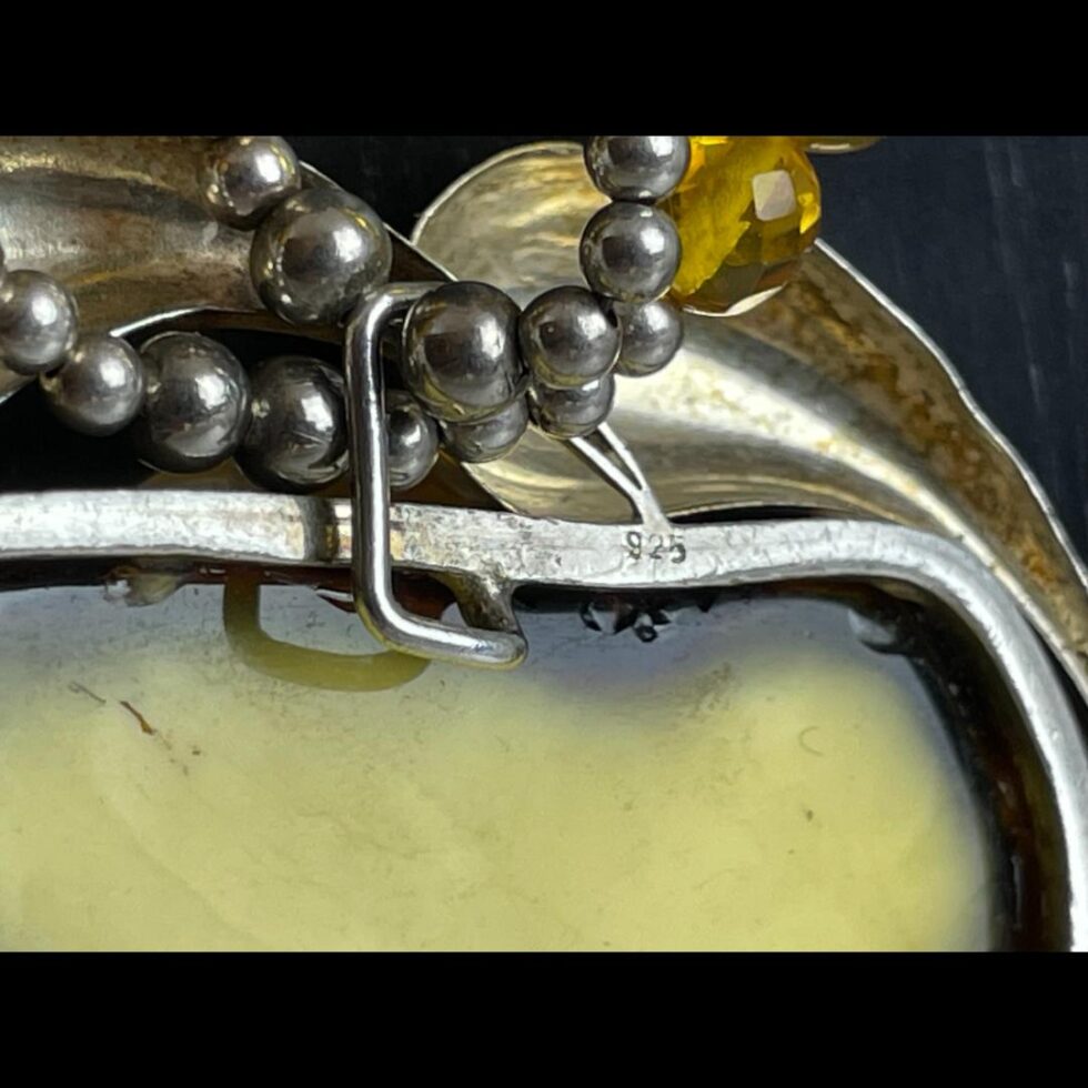 Close up photo of the 925 hallmark at the back and top of pendant by the bail. The silver ball beads which are only at the bail of the pendant and the clasp are also seen in close up here.