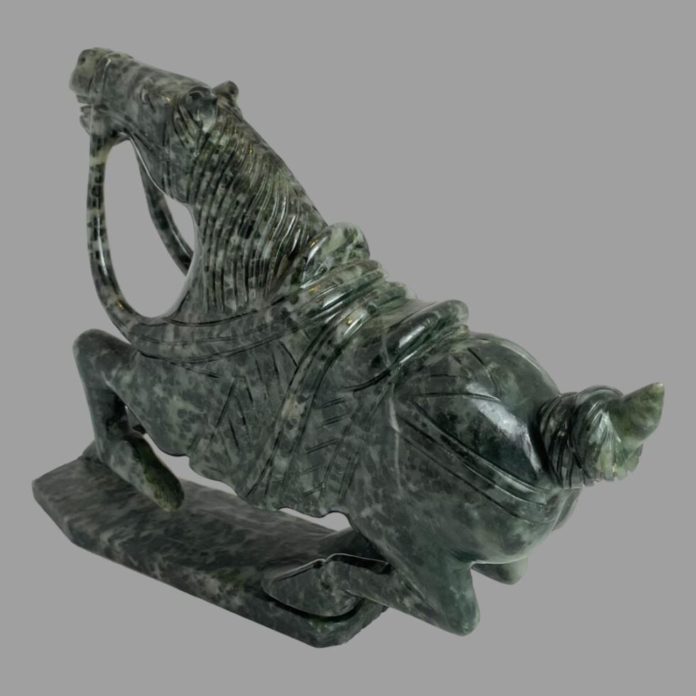 This time the serpentine stone warrior horse is facing towards the top left corner and its hind end in bottom right. The tail has been neatly knotted in the carving.