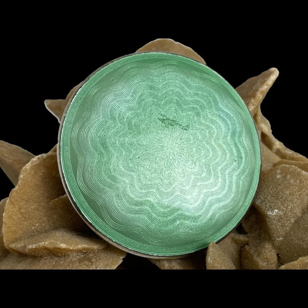 Photo of the base of the compact with one mark near the centre.