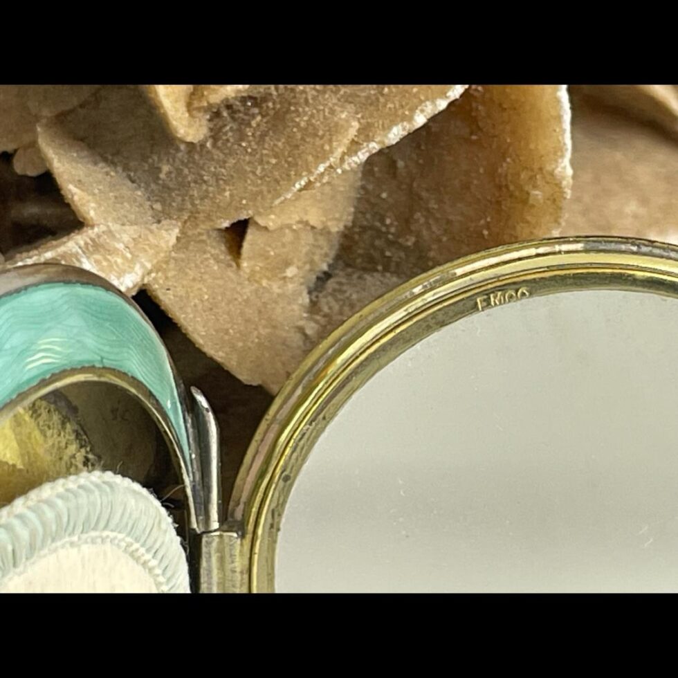 Close up photo of the FMCo makers mark on the inside rim of mirror.