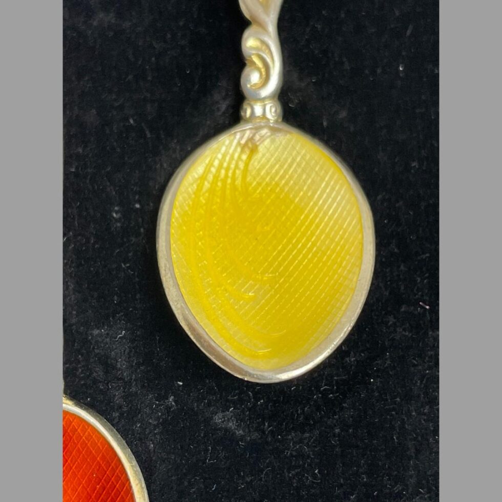 A close up photo of the bowl of the yellow spoon showing the minor wear at top of bowl below the handle.