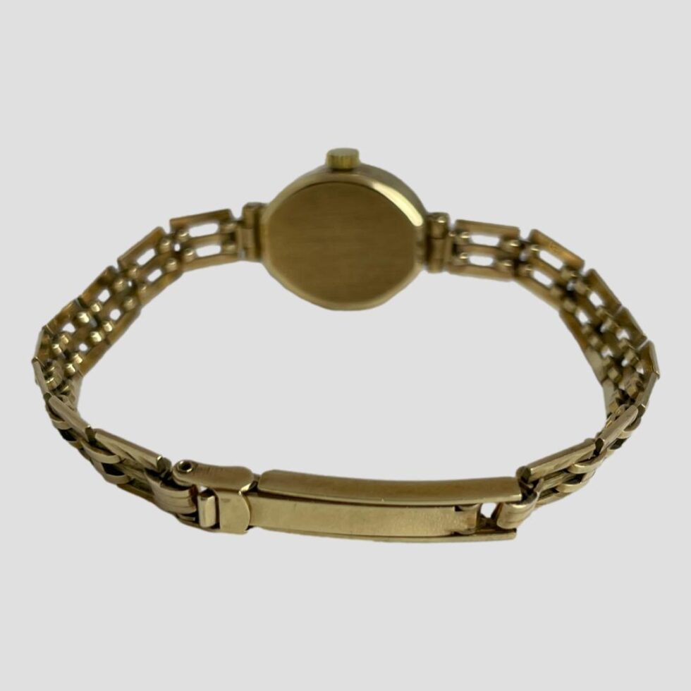 Photo of ladies Rotary watch displayed on flat surface with watch face facing away from camera. The clasp is shown completely closed.