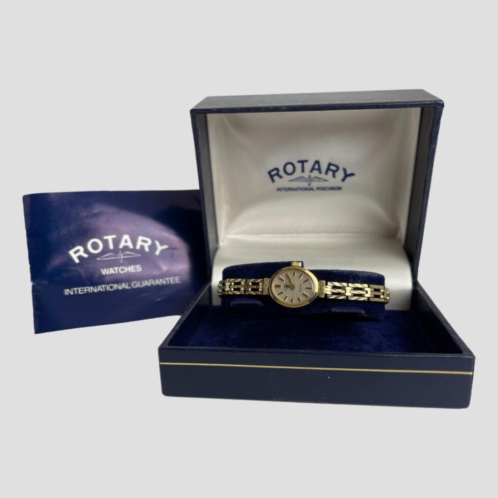 Main photo of 9kt ladies Rotary watch displayed inside its original case with the purchase of receipt document to the left of box. The watch face is oval and small so best suited for someone with good eye sight.
