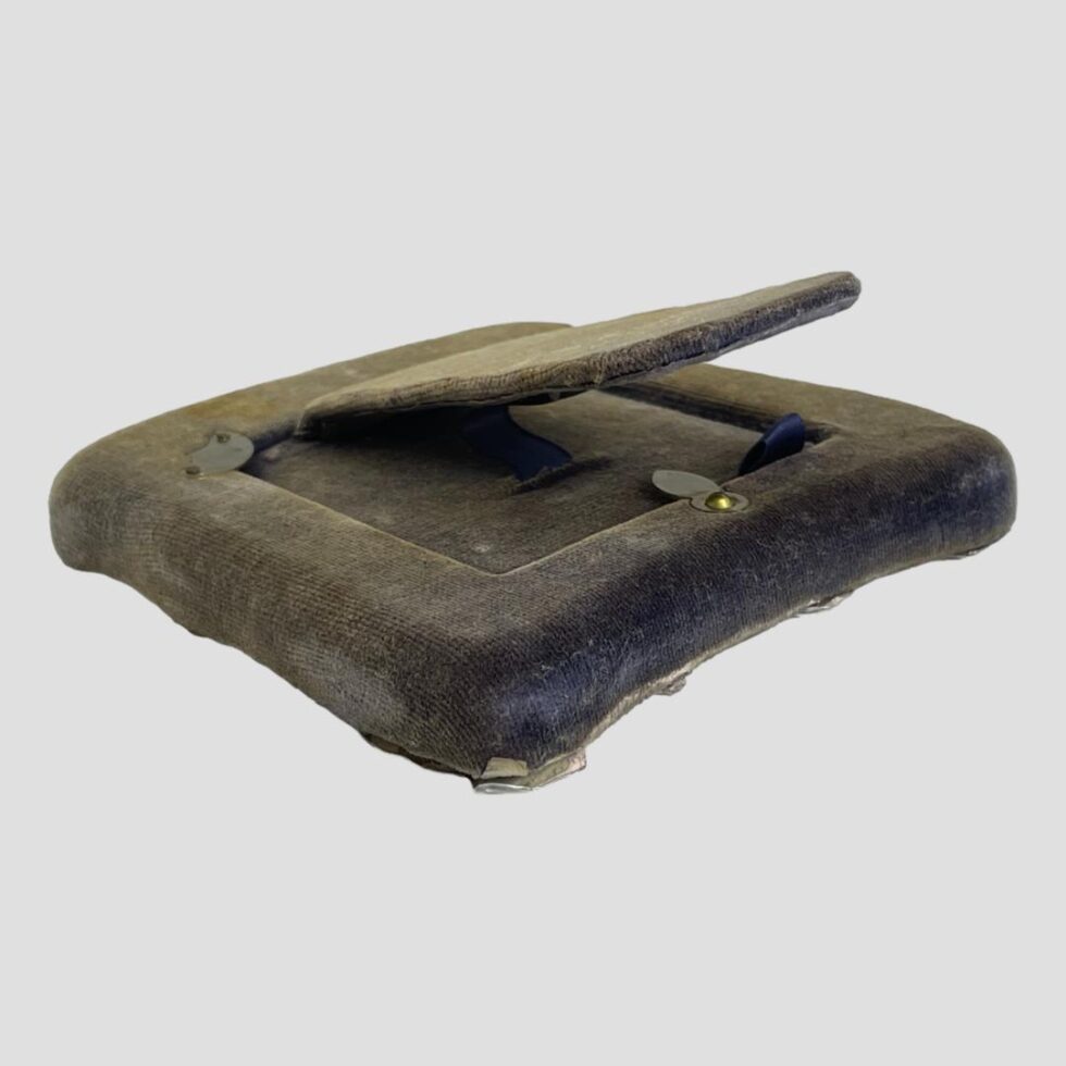 Photo of frame laid face down displaying the area below the stand at the back. The velvet is blue here.