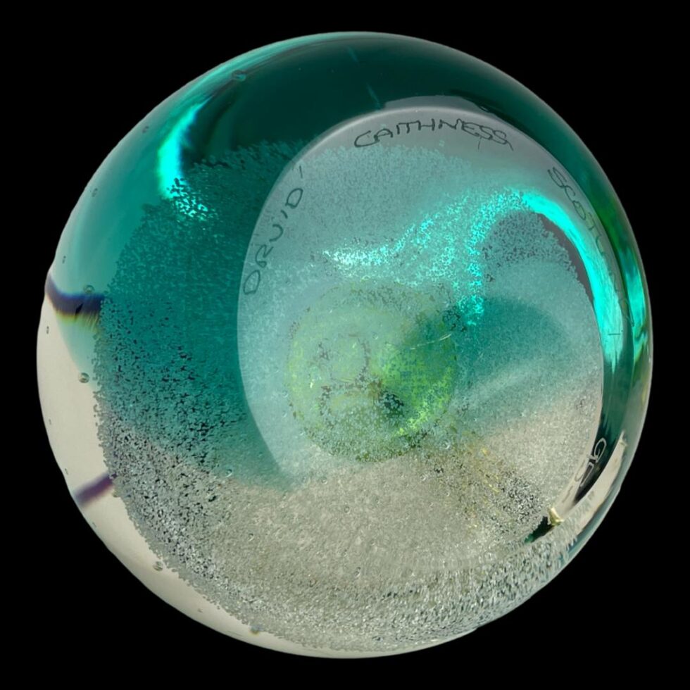 Photo of the base of the Caithness druid paperweight with Druid Caithness Scotland visible along the top and number 95 just visible along the bottom.