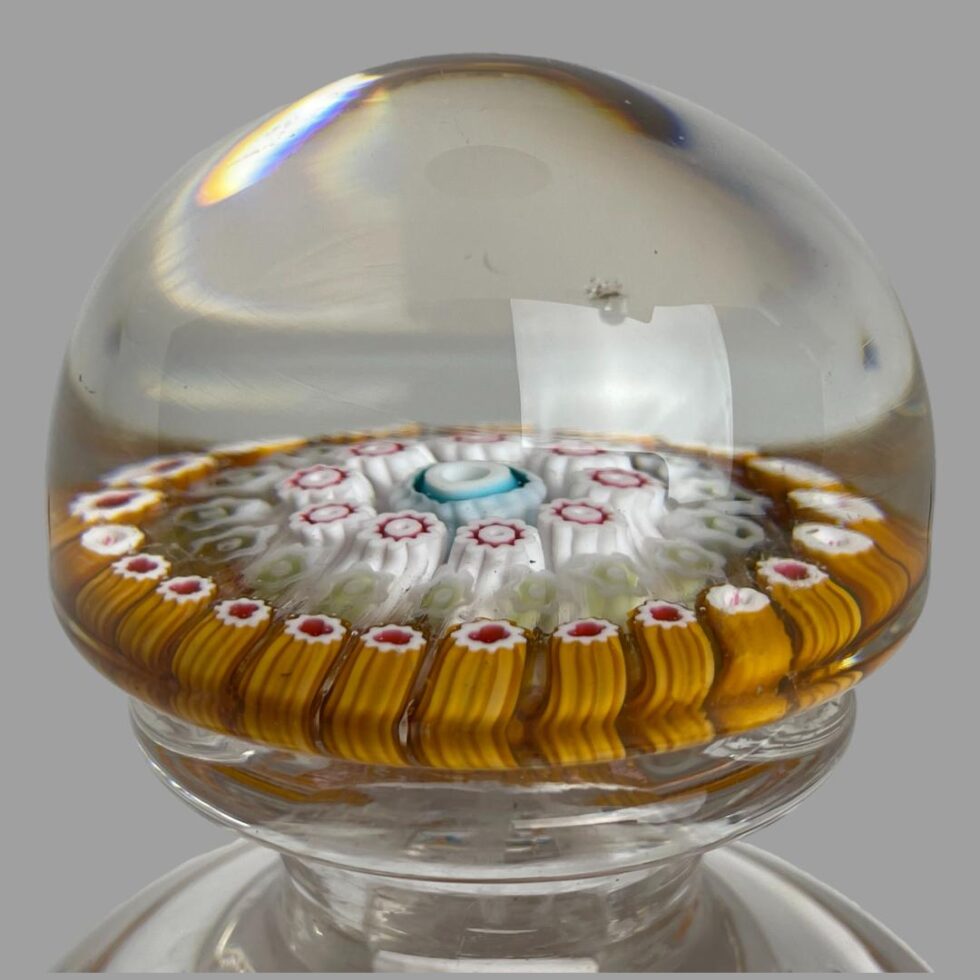 A close up photo of a chip on the glass domed lid.