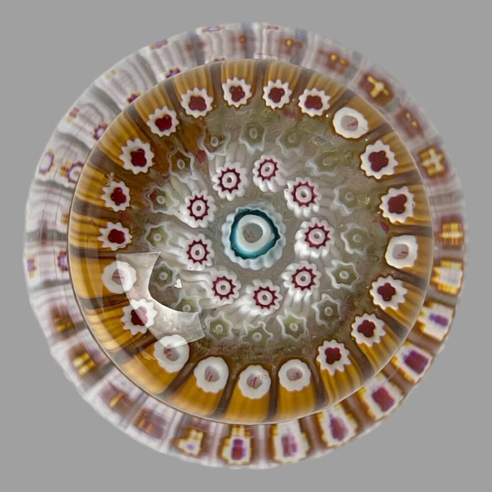 Photo looking straight down at the inkwell from above. The lid is in place and it looks like one paperweight with fuzzy edge.