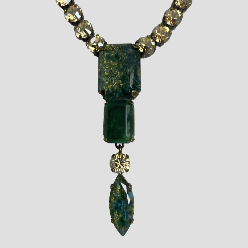 A close up photo of the pendant area of Philippe Ferrandis designer necklace.