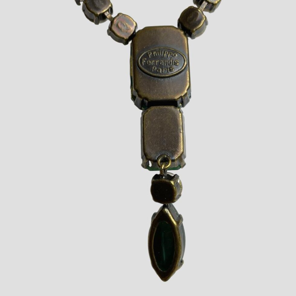 Close up photo of the back of the pendant area of necklace showing the makers mark.