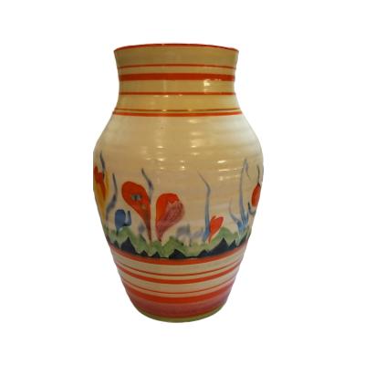 Photo of vase seen with least crocus flowers - a continuation of the crocus theme - these are mostly orange.