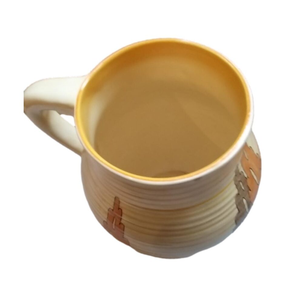 Photo looking down into the mought of the jug. The haldle is to the left.