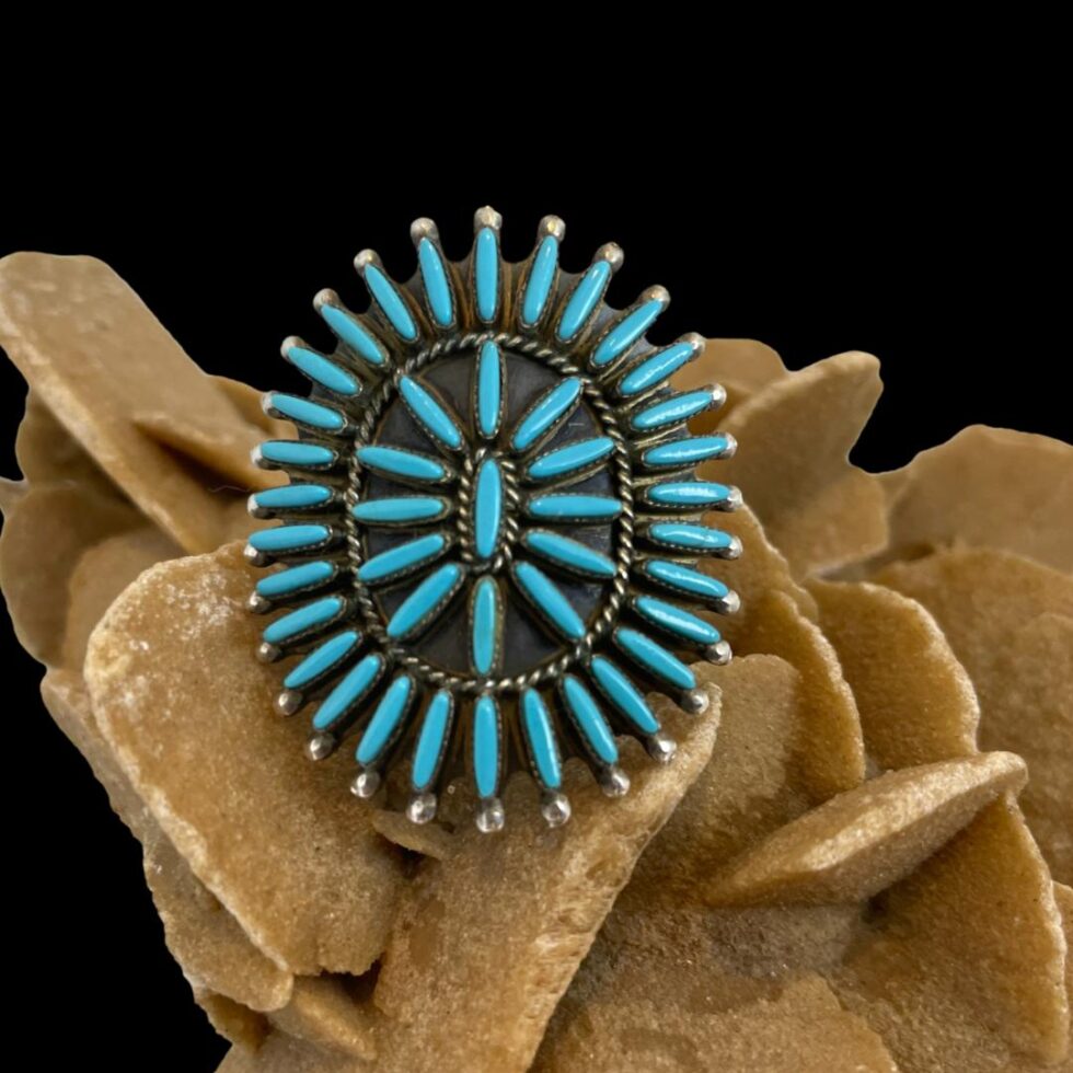 Photo of the ring only shown forward facing on the rock of desert sand rose.