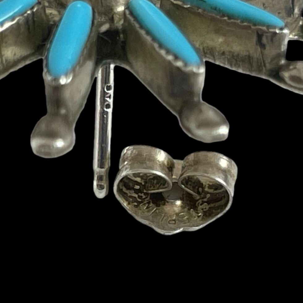 Close up photo of the hallmarks on one earring post and butterfly.