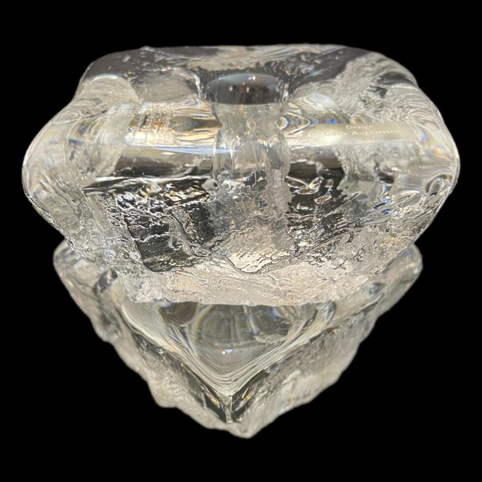 Photo of ice cube candle holders displayed with one stacked on top of the other. The lower one has a pointed corner jutting out and top one has flat side and top on display.