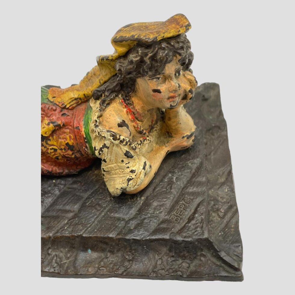 Close up of top half of Bedouin girl looking down diagonally.