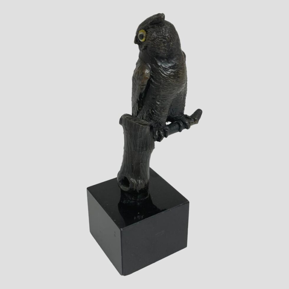 This time we are looking at the small bronze owl with one corner of square marble base in the foreground. At this angle the owl looks as if it is looking behind him but one beady yellow glass eye is keeping its eye on you! At this angle the perch is visible and the whole tree trunk.