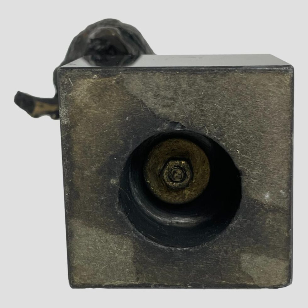 Photo of the base of the vintage owl bronze showing the bronze attached to marble base by a nut.