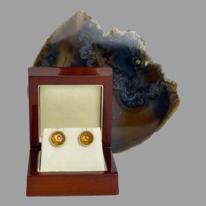 Main photo of carved citrine gold studs displayed inside their lacquer wood box. There is a slice of natural agate behind the open box.