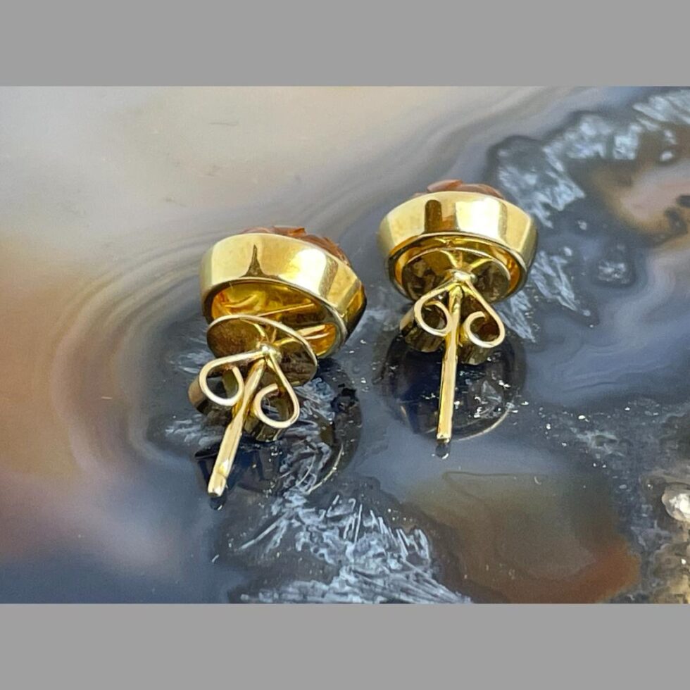 Photo of the back of both carved citrine earrings showing the butterflies which have a flat edge to fix securely against the ear lobe.