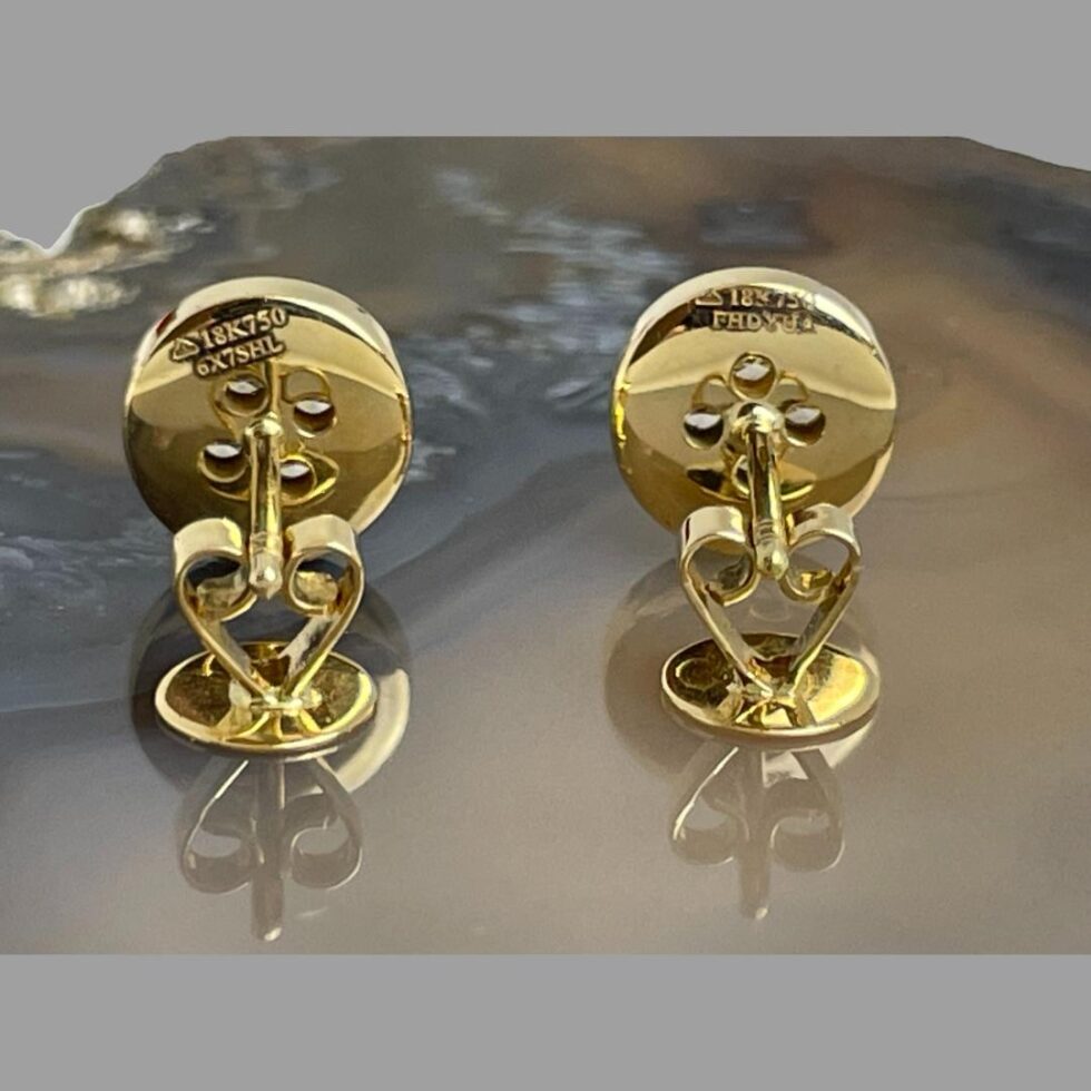 Photo of both button earrings displayed side by side, facing away from camera and butterflies removed. The posts are resting on the butterflies with are flat side down and the hallmark is clearly visible to the back of both earrings.