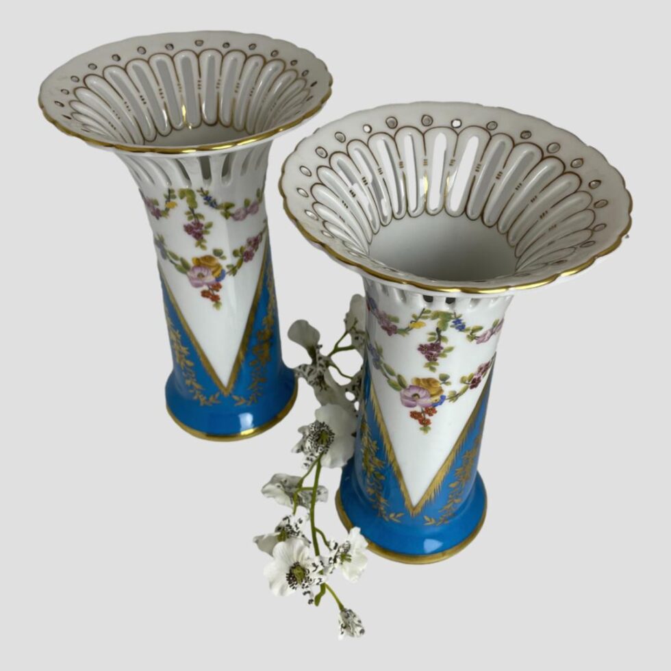 Photo of Sèvres style porcelain vases this time seen from slightly raised angle looking diagonally downward at the vase tops.