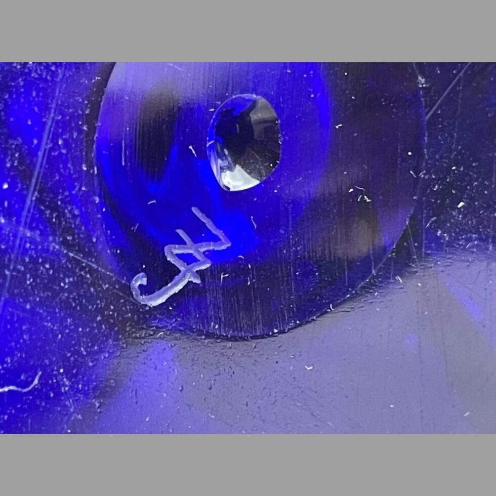 Close up photo of the initials on the base of 3 point vase.