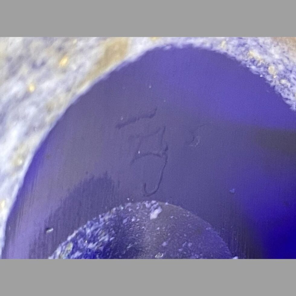 Close up photo of the initials on the base of 2 pointed tip vase.