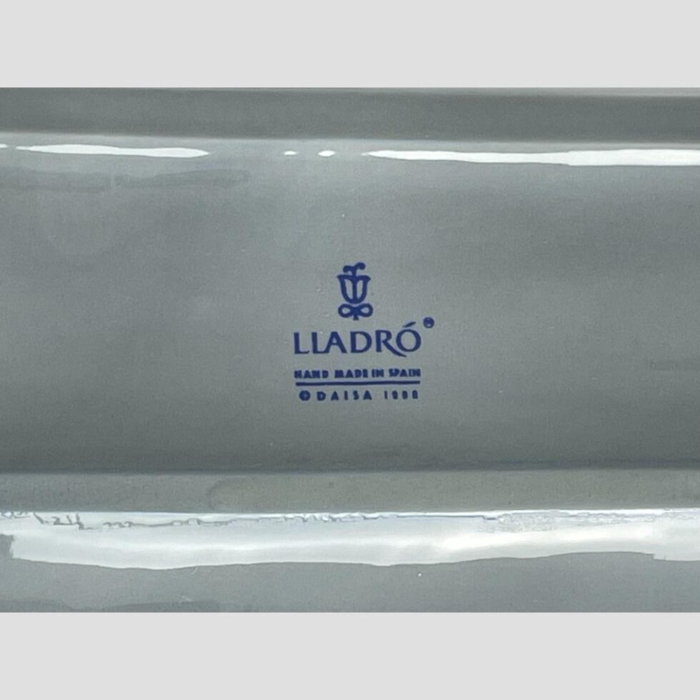 Close up photo of the Lladro mark on the car base and year.