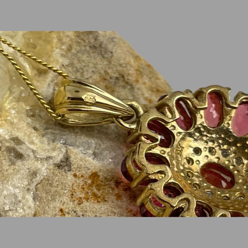 Photo close up of the hallmark to the back of pendant and back of pendant bail.